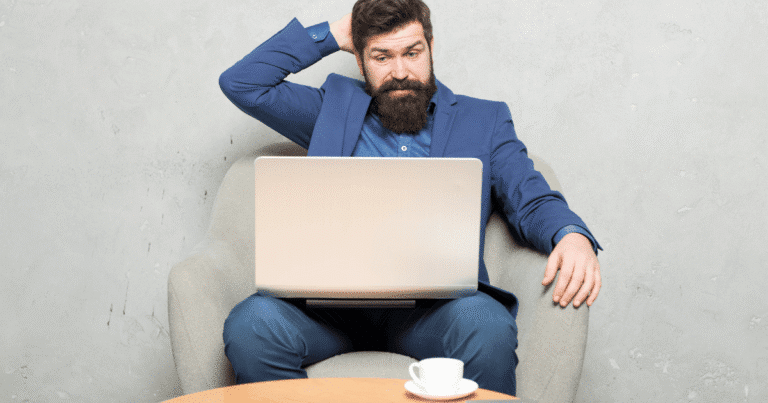 Hombre con cara de frustración pensando en la estructura de un blog en un portátil